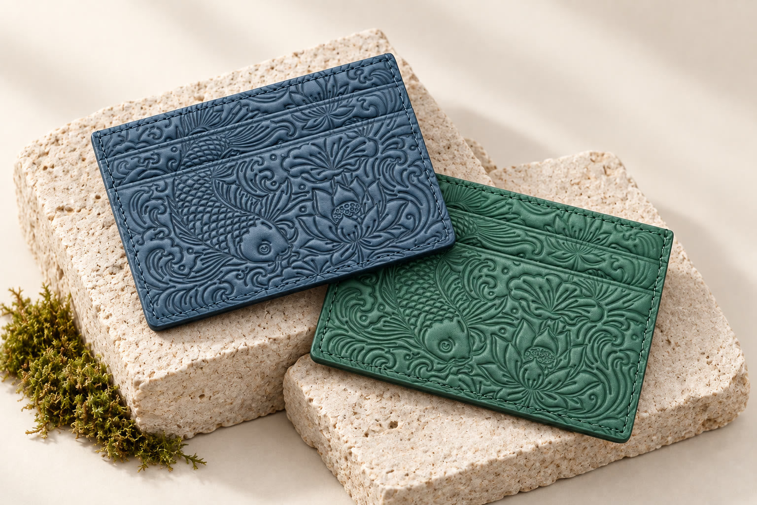Emerald green and oceanic blue embossed koi leather card holders in our stone studio setting